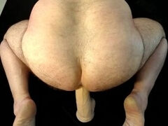 Bi-guy takes long dildo up the ass, rear view