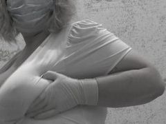 Nurse with big natural tits in medical gloves masturbates her holes to orgasm.