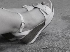 Women's feet in sandals on a high platform,